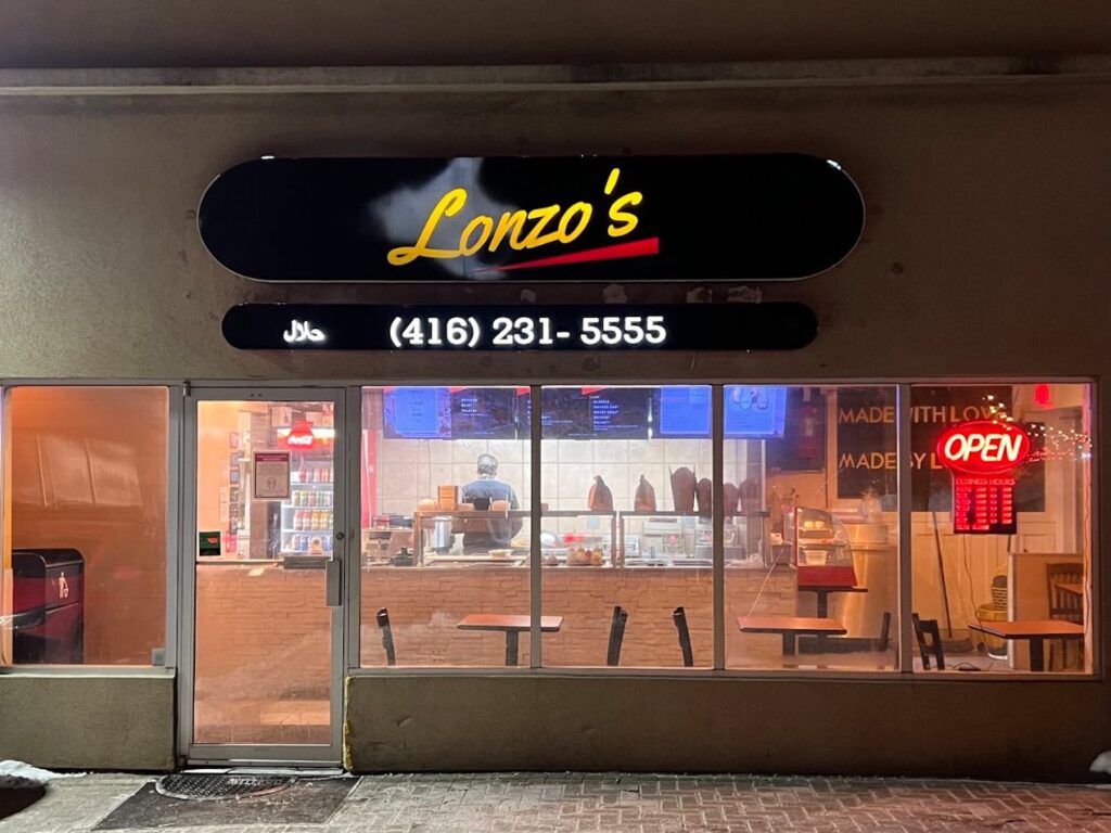 Lonzo’s Etobicoke at night, with the lit Lonzo’s sign and phone number above the front windows